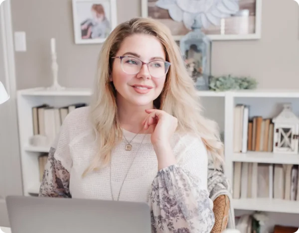 Woman smiling while using her laptop at home