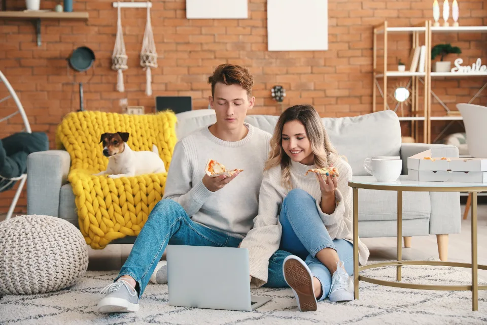 Couple at home looking at a laptop